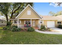 Cute yellow house with a covered porch and well-manicured lawn at 8450 Sw 90Th St # A, Ocala, FL 34481