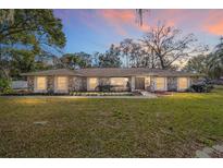 Single-story home with stone facade, and a large grassy yard at 2528 Se 15Th St, Ocala, FL 34471