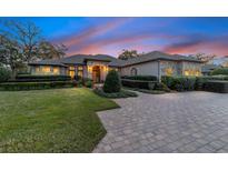 Elegant home with stone accents, landscaping, and paver driveway at 2802 Se 28Th St, Ocala, FL 34471