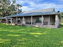 Ranch home with large porch and metal roof at 4880 Bannon Island Rd, Haines City, FL 33844