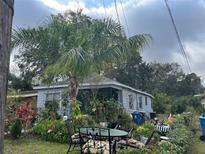 Charming house with lush landscaping and patio seating at 323 Dorsett Ave, Lake Wales, FL 33853