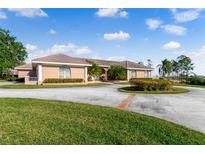 Beautiful home with circular driveway and landscaping at 3082 Landings Ct, Haines City, FL 33844
