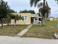 One-story yellow house with a spacious yard at 315 Virginia St, Frostproof, FL 33843