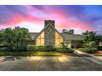 A-frame home with stone fireplace and beautifully landscaped yard at 514 Hillside Dr, Auburndale, FL 33823