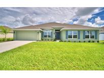 One-story house with green exterior and landscaping at 4024 Tullamore Ln, Auburndale, FL 33823