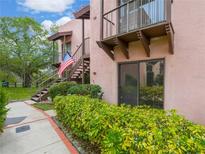 Two-story condo building with private balconies and lush landscaping at 104 La Casa # 104, Lake Wales, FL 33898
