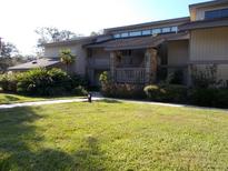 Exterior view of condo building, showcasing landscaping and building features at 4171 Abbey Ct # 4171, Haines City, FL 33844