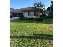 Single-story home with a well-manicured lawn and attached garage at 680 Augusta Rd, Winter Haven, FL 33884