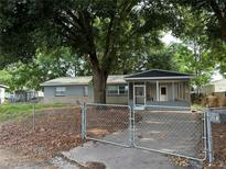 Gray house exterior with screened porch and fenced yard at 152 E Grove Dr, Haines City, FL 33844