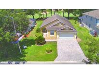 House with driveway and landscaped yard at 1608 Forest Hills Ln, Haines City, FL 33844