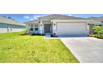 Attractive single-story house with a two-car garage and well-manicured lawn at 2123 Cartgate Lane, Winter Haven, FL 33884