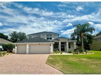 Two-story home with a large driveway and manicured lawn at 1876 Eloise Cove Dr, Winter Haven, FL 33884