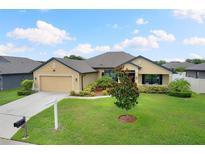 One-story home with two-car garage and well-manicured lawn at 6421 Alamanda Hills Dr, Lakeland, FL 33813