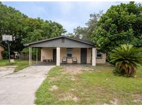 Brick home with covered porch, mature landscaping, and a basketball hoop at 2920 Gause St, Bartow, FL 33830