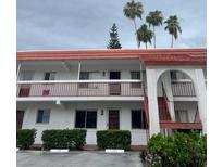 Two-story building exterior with red tile roof at 400 El Camino Dr # 223, Winter Haven, FL 33884