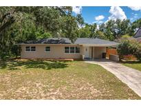 Newly renovated single story home with a carport and well-maintained lawn at 656 Lorraine Cir, Lake Wales, FL 33853