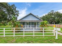 Charming bungalow with white picket fence and lush landscaping at 954 Reynolds Rd, Lakeland, FL 33801
