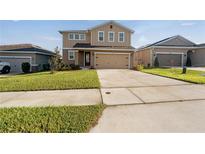 Two-story house with a two-car garage and a well-maintained lawn at 339 Lake Smart Cir, Winter Haven, FL 33881