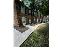 Brick building exterior with multiple units and walkways at 5850 Cypress Gardens Blvd # 105, Winter Haven, FL 33884