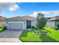 Gray house with a two-car garage and a landscaped yard at 2505 Salzburg Loop, Winter Haven, FL 33884