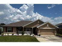 Single-story house with a landscaped yard and attached garage at 218 Brookshire Dr, Lake Wales, FL 33898