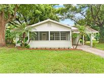 Charming renovated home with a screened porch and manicured lawn at 1165 E Church St, Bartow, FL 33830