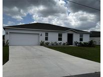 Newly built home with a two-car garage and well-maintained lawn at 177 Cimarron Ln, Kissimmee, FL 34759