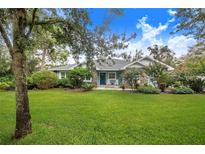 One-story home with blue exterior and landscaped yard at 2931 Chickasaw Cir, Haines City, FL 33844