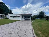 Single-story home with carport and nicely landscaped yard at 807 Elizabeth Ln, Lakeland, FL 33809