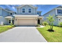 Two-story house with attached garage and landscaped yard at 1476 Leamington Lane, Winter Haven, FL 33884