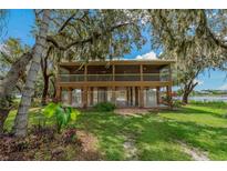 Elevated home with screened porch overlooking the lake at 3038 Spirit Lake Dr, Winter Haven, FL 33880