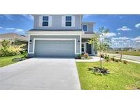 Two-story house with a gray exterior and attached garage at 1480 Leamington Lane, Winter Haven, FL 33884