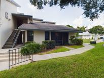 Ground level condo entrance with stairs and landscaping at 2049 San Marcos Se Dr # 127, Winter Haven, FL 33880