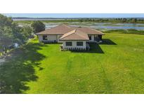 Aerial view of home showcasing expansive backyard and lake views at 553 Thornburg Rd, Babson Park, FL 33827