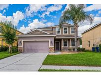 Two-story house with a landscaped lawn and attached garage at 3540 Julius Estates Blvd, Winter Haven, FL 33881