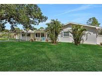 Charming ranch home with lush lawn and mature trees at 937 Avenue L Se, Winter Haven, FL 33880