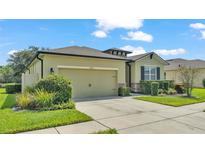 Single-story house with a two-car garage and landscaping at 5852 Marsh Landing Dr, Winter Haven, FL 33881