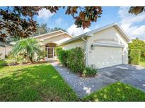 Single story home with two car garage and landscaped yard at 4189 Cannes Ave, Lake Wales, FL 33859