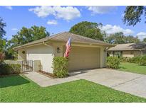 Single-story home with attached garage and manicured lawn at 466 Muirfield Ct, Winter Haven, FL 33884