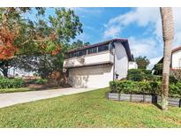 Two-story home with attached garage at 6001 Country Club Dr, Lake Wales, FL 33898