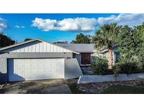House exterior with white garage door and red front door at 672 Wakulla Dr, Winter Haven, FL 33884