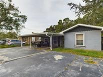 Front view of a house with a carport, and a small front yard at 3511 Avenue R Nw, Winter Haven, FL 33881
