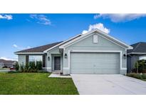 One-story house with light green exterior and two-car garage at 1274 Zambrana Ct, Winter Haven, FL 33884