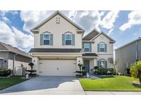 Two-story house with a large yard and two-car garage at 940 Waterville Dr, Auburndale, FL 33823