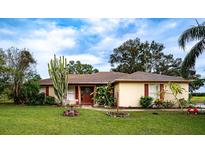 Ranch style home with a manicured lawn and mature landscaping at 1937 Rifle Range Rd, Winter Haven, FL 33880