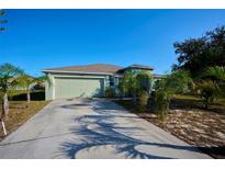 Single-story home with two-car garage and palm trees at 2608 Sunset Cir, Lake Wales, FL 33898