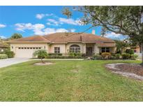 One-story house with a two-car garage and a well-maintained lawn at 3002 Plantation Rd, Winter Haven, FL 33884