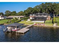 Luxury waterfront home with private dock, boat lift, and screened pool; expansive backyard at 1324 Mirror Nw Ter, Winter Haven, FL 33881