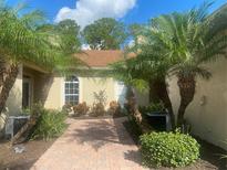 Brick walkway to front door, palm trees at 1561 Vienna Square Dr, Winter Haven, FL 33884
