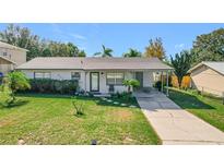Single-story home with a carport and well-maintained lawn at 221 Dorothy St, Auburndale, FL 33823